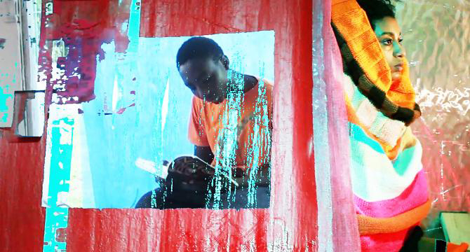 Vivid composition of abstract fabric fields, a child reading, and a woman swathed in fabric